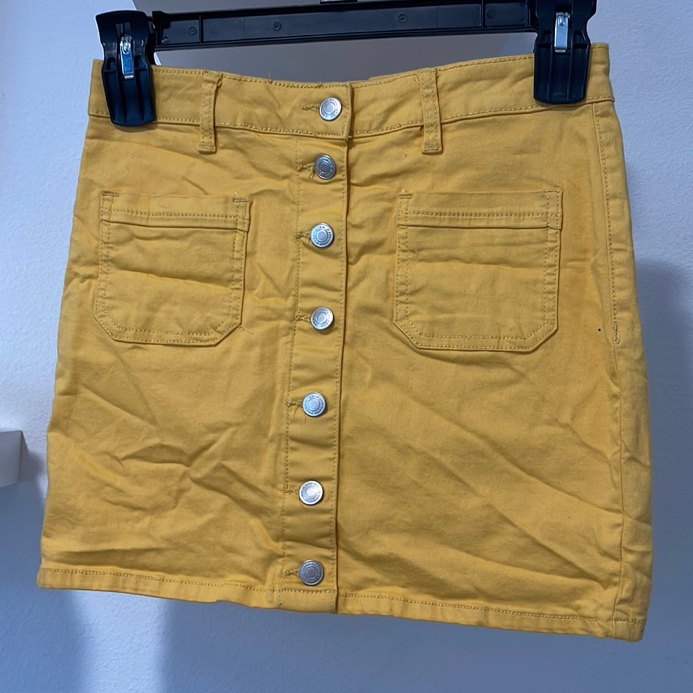 Two pocket; mustard color skirt.